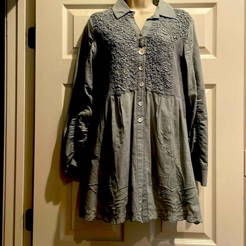 Pretty light green blouse with beautiful details in stitching and buttons.
